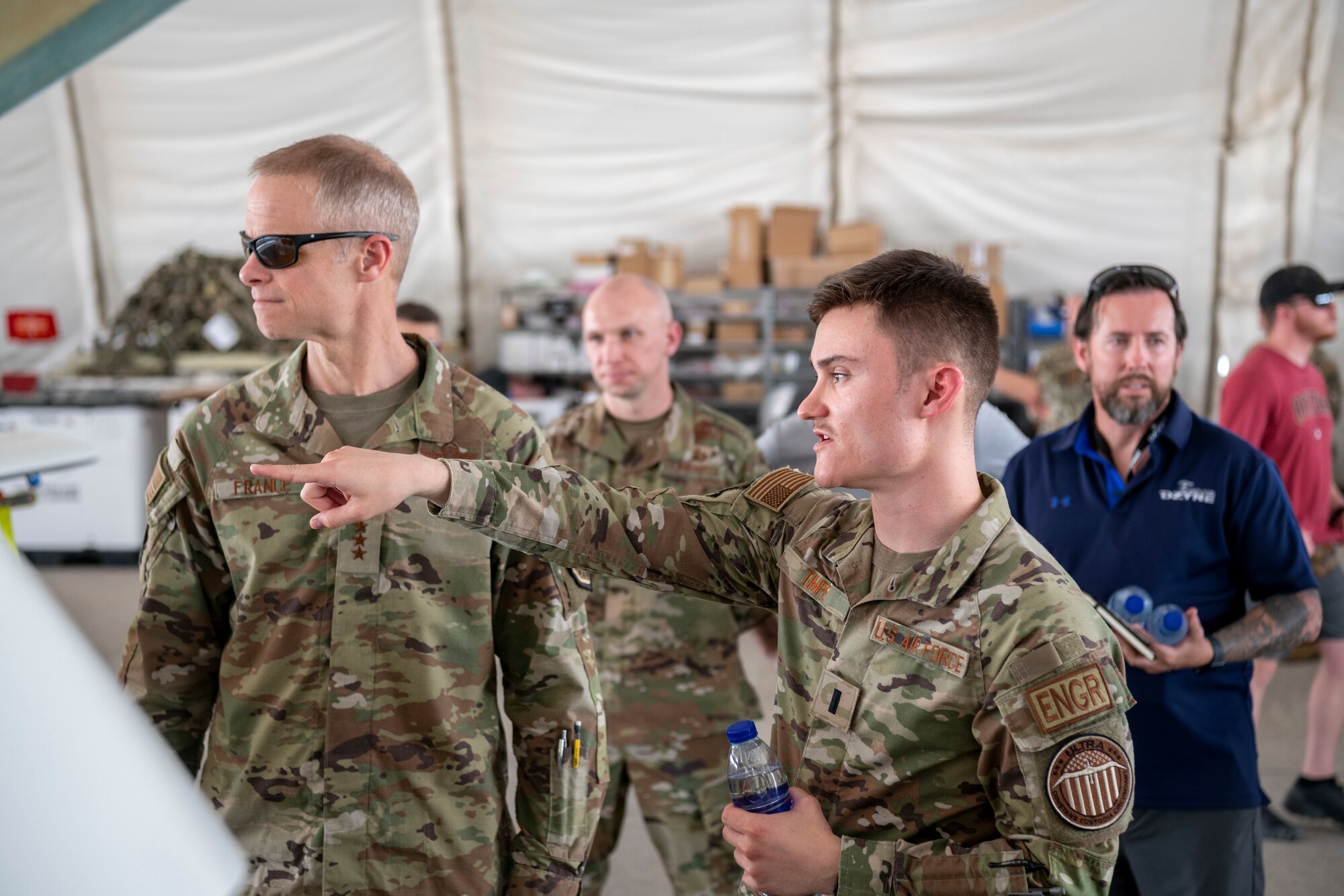 U.S. Air Force Lt. Gen. Derek France, Ninth Air Force commander, speaks with members of the ULTRA Long Endurance Unmanned Aerial System team about the ULTRA during a visit to the 380th Air Expeditionary Wing at an undisclosed location within the U.S. Central Command area of responsibility, April 29, 2024. ULTRA is a remote piloted intelligence, surveillance and reconnaissance aircraft capable of 80 hours of continuous flight. France, who recently took command of Ninth Air Force, visited the wing to get a better understanding of its current operational capabilities, better enabling him to make informed decisions throughout the region. (U.S. Air Force photo)