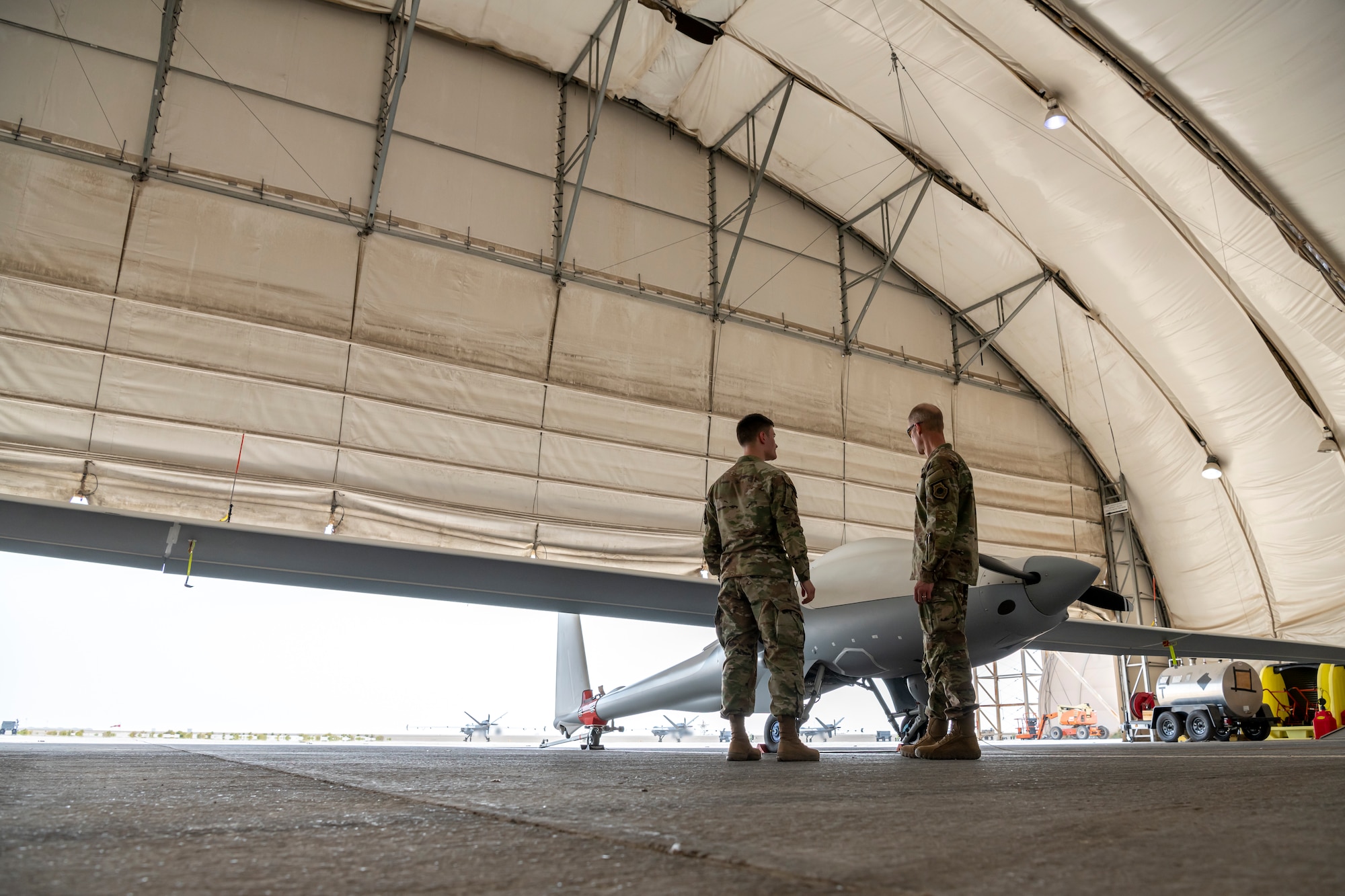 U.S. Air Force Lt. Gen. Derek France, Ninth Air Force commander, speaks with A member of the ULTRA TEAM about the ULTRA during a visit to an undisclosed location within the U.S. Central Command area of responsibility, April 29, 2024. ULTRA is a remote piloted intelligence, surveillance and reconnaissance aircraft capable of 80 hours of continuous flight. France, who recently took command of Ninth Air Force, visited the wing to get a better understanding of its current operational capabilities, better enabling him to make informed decisions throughout the region. (U.S. Air Force photo)
*Some Photographic elements have been blurred for security purposes