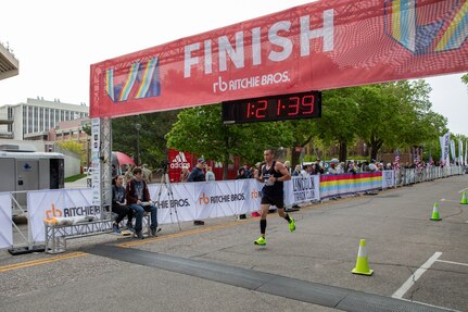 Puerto Rico National Guard runner Sgt. Angeles Virella crosses the finish line of the 47th annual Lincoln Marathon and Half Marathon May 5, 2024, in Lincoln, Nebraska. The Nebraska National Guard has a long history of supporting the Lincoln Marathon, which biennially serves as the time trials for the National Guard All Guard Marathon Team.