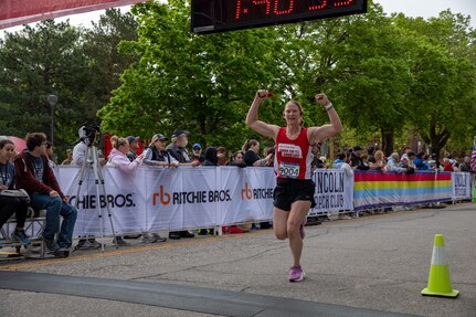 Nebraska National Guard runner Maj. Amanda Schmid crosses the finish line of the 47th annual Lincoln Marathon and Half Marathon May 5, 2024, in Lincoln, Nebraska.