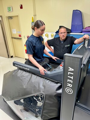 Dr. Robert Eberly and HM3 Abby start up the anti-gravity treadmill to demonstrate the capabilities.