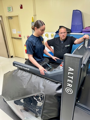 Dr. Robert Eberly and HM3 Abby start up the anti-gravity treadmill to demonstrate the capabilities.