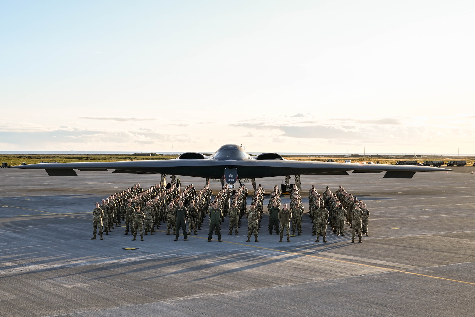 A group of Airmen standing in front of a B2 bomber aircraft