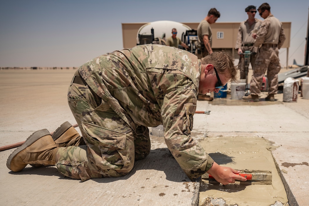 A U.S. Air Force pavement and equipment technician assigned to the 378th Expeditionary Civil Engineer Squadron repairs the flightline at an undisclosed location within the U.S. Central Command area of responsibility, May 4, 2024. The Airmen and Marines came together to improve operational resilience and share best practices. (U.S. Air Force photo)