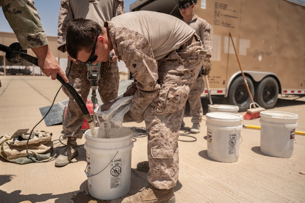 A U.S. Marine Corps combat engineer assigned to the 2nd Marine Logistics Group creates a concrete mix to repair the flightline at an undisclosed location within the U.S. Central Command area of responsibility, May 4, 2024. Total force integration with the U.S. Marine Corps demonstrates the U.S.’ enduring commitment to global security (U.S. Air Force photo)