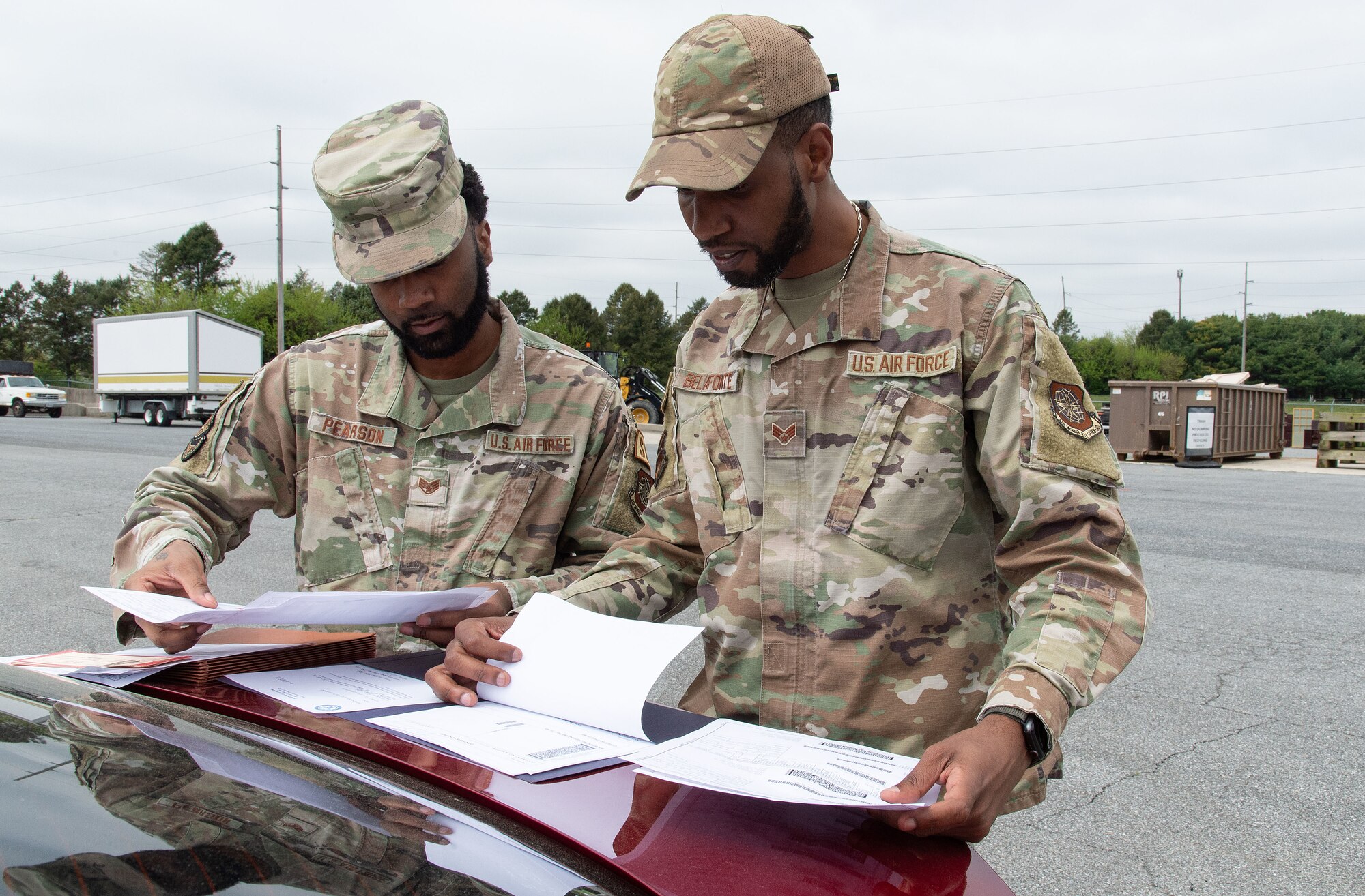 U.S. Air Force Staff Sgt. MyIshmial Pearson, left, 436th Logistics Readiness Squadron flight service center supervisor, and Senior Airman Ramon Belafonte, right, 436th LRS Defense Logistics Agency Air Force representative, review documentation for assets brought in for disposition during the Recycling Center Open House at Dover Air Force Base, Delaware, April 18, 2024. Squadrons from across the base turned in unwanted and excess items to the center for proper disposition. (U.S. Air Force photo by Roland Balik)