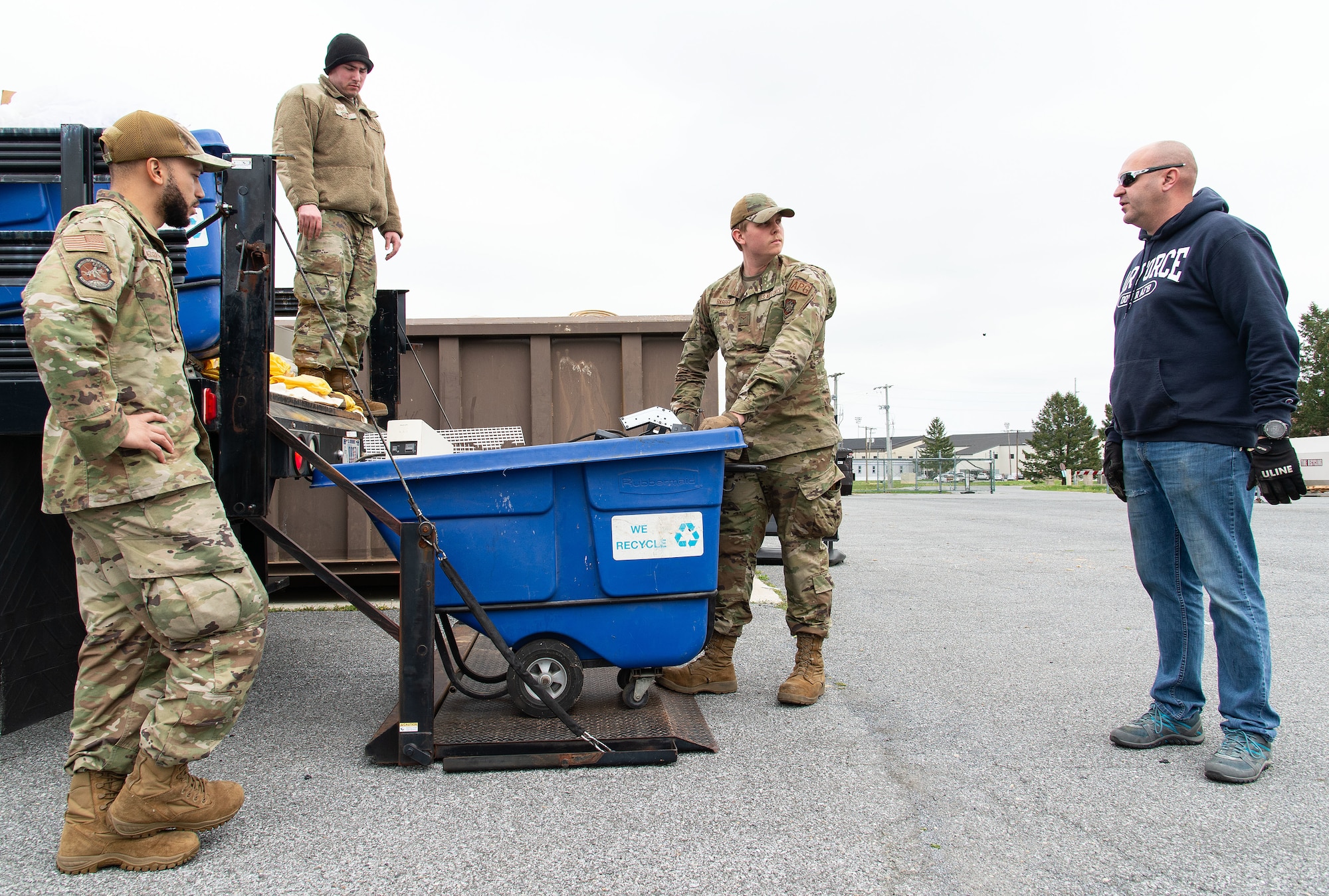 Ken Riley, right, 436th Civil Engineer Squadron Qualified Recycling Program manager, instructs Airmen where to place items during the Recycling Center Open House at Dover Air Force Base, Delaware, April 18, 2024. Squadrons from across the base turned in unwanted and excess items to the center for proper disposition. (U.S. Air Force photo by Roland Balik)