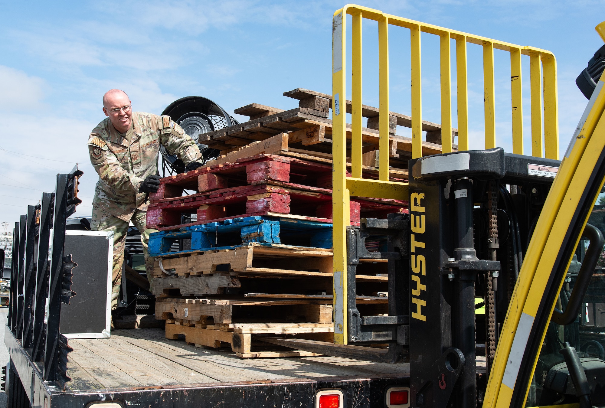 U.S. Air Force Senior Master Sgt. Doug Lundquist, 436th Security Forces Squadron logistics and readiness superintendent, loads unwanted wooden pallets for disposition during the Recycling Center Open House at Dover Air Force Base, Delaware, April 18, 2024. Squadrons from across the base turned in unwanted and excess items to the center for proper disposition. (U.S. Air Force photo by Roland Balik)