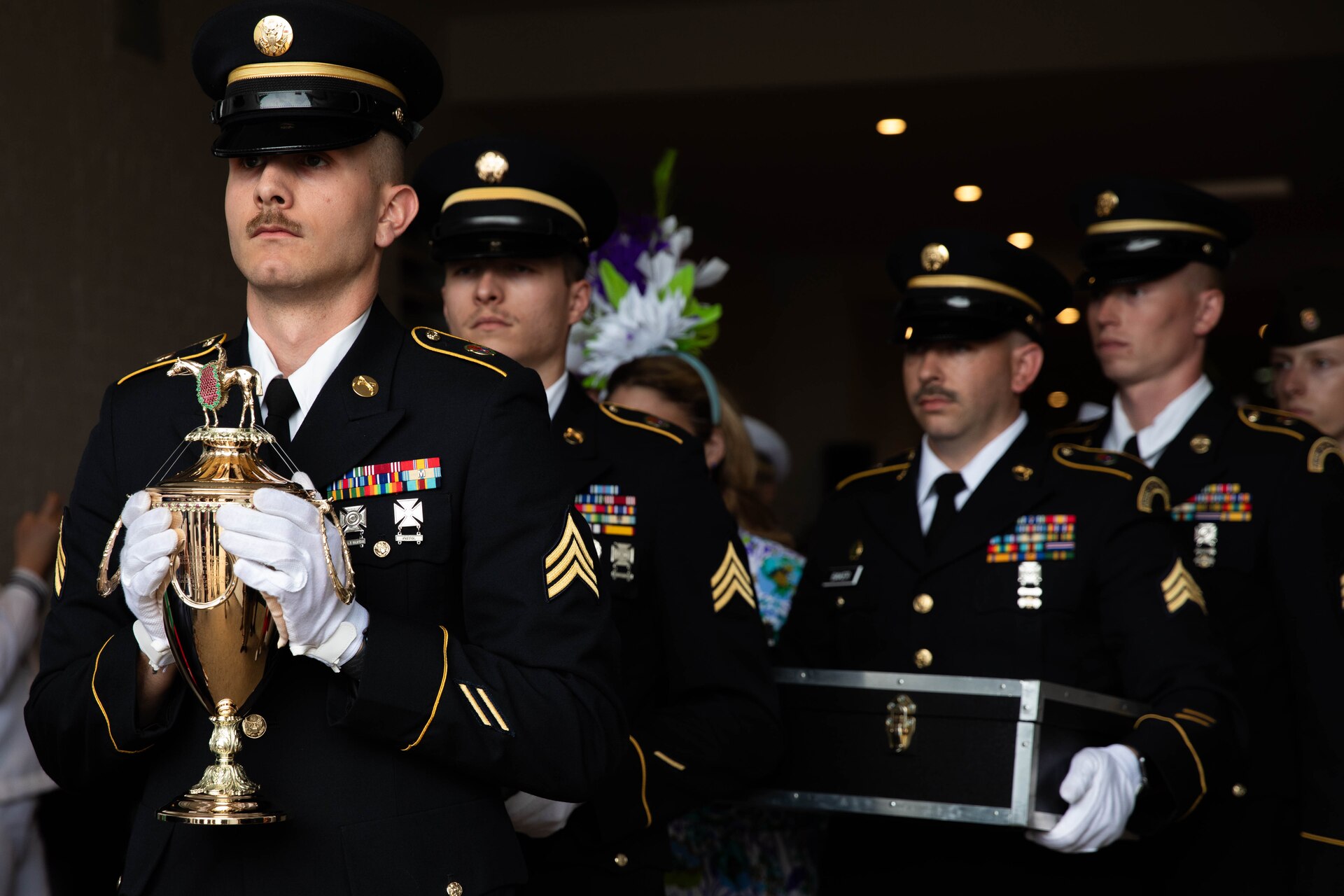 Soldiers of the 940th Military Police Company, 149th Maneuver Enhancement Brigade guard the winner’s trophy at the 150th Kentucky Derby at Churchill Downs, Louisville, Kentucky, May 4, 2024. The Kentucky Army National Guard carries a long tradition of escorting the winner’s cup dating back decades. (U.S. Army National Guard photo by Sergeant Caleb Sooter)