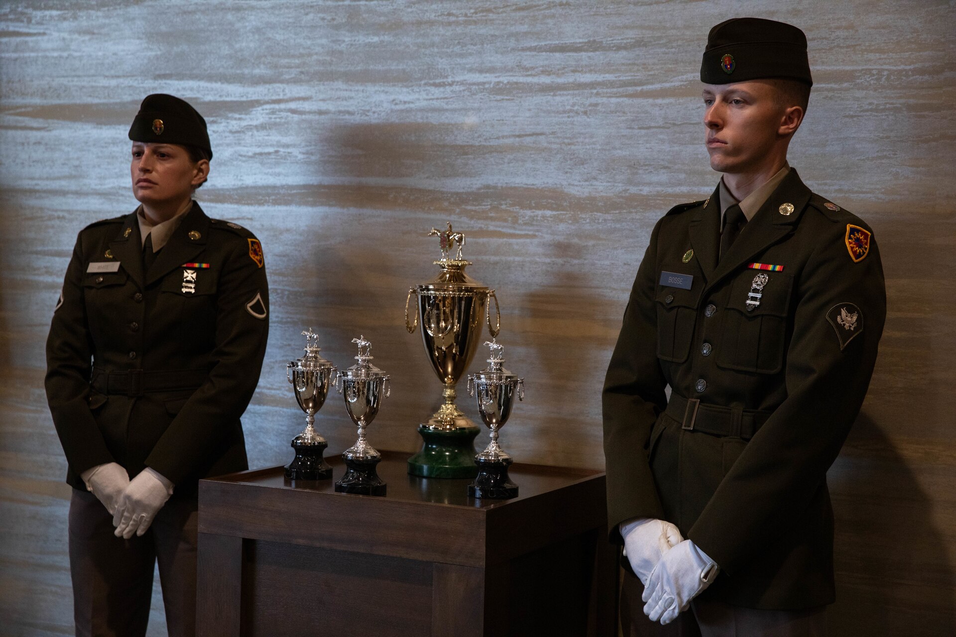 Soldiers of the 940th Military Police Company, 149th Maneuver Enhancement Brigade guard the winner’s trophy at the 150th Kentucky Derby at Churchill Downs, Louisville, Kentucky, May 4, 2024. The Kentucky Army National Guard carries a long tradition of escorting the winner’s cup dating back decades. (U.S. Army National Guard photo by Sergeant Caleb Sooter)