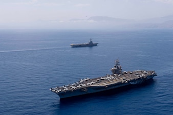 USS Dwight D. Eisenhower (CVN 69) and the French aircraft carrier FS Charles De Gaulle (R91) transit the Mediterranean Sea.