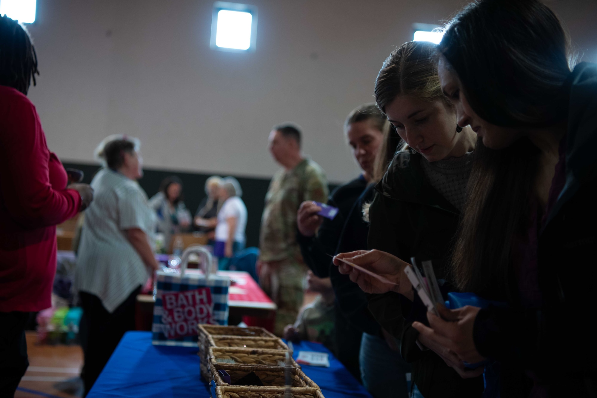 Military spouses look at a display table