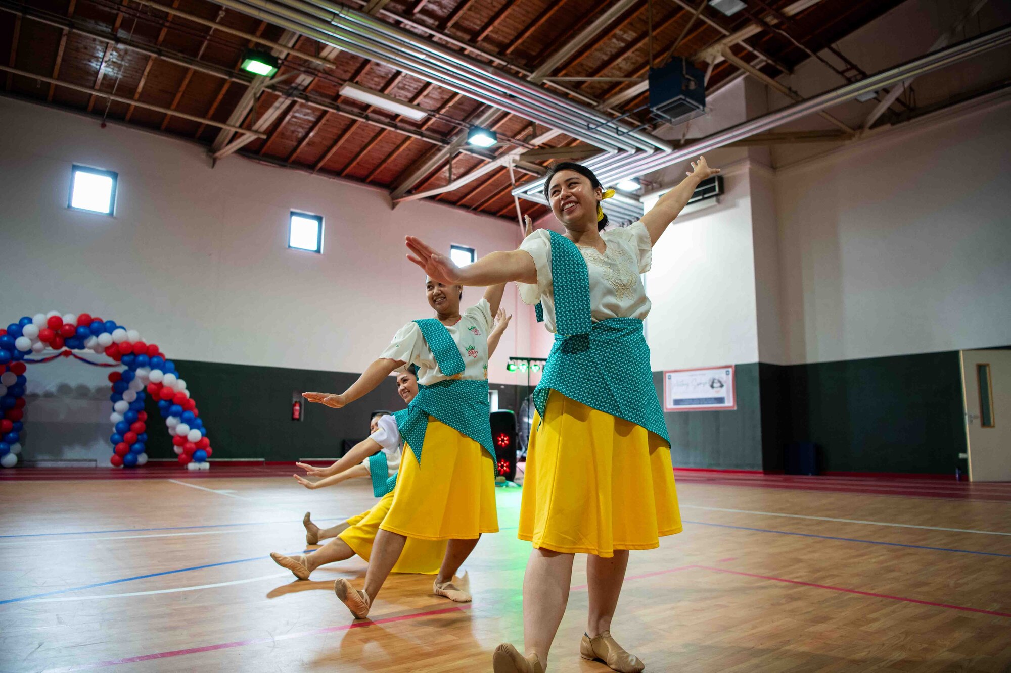 Filipino community members perform a traditional dance