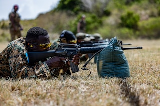 Service members from the St. Lucia Defence Force, the Royal Bahamas Defence Force and the St. Kitts and Nevis Defence Force, group and zero their weapons in Barbados, during TRADEWINDS 24 (TW24) on May 4, 2024