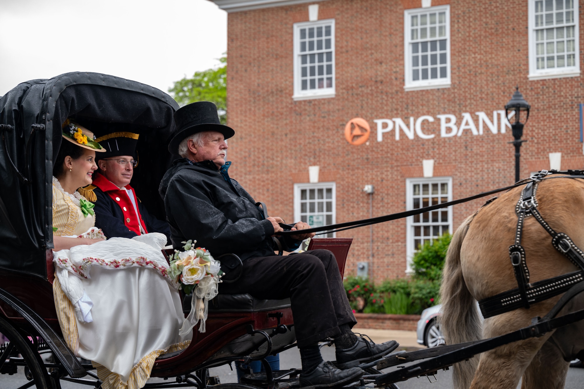 U.S. Air Force Col. Chris McDonald, 436th Airlift Wing commander, and his wife, Diana McDonald, ride in a horse-drawn carriage during the Dover Days Parade in Dover, Delaware, May 4, 2024. The McDonald’s dressed in colonial attire for the 91st Annual Dover Days Festival and Parade, an event that highlights the First State’s history and heritage. (U.S. Air Force photo by Airman 1st Class Amanda Jett)