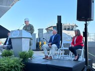 Capt. Scot Searles, Unmanned Maritime Systems Program Manager, addresses attendees during the Vanguard christening ceremony, 25 April.