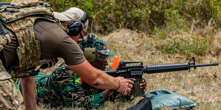 A 7th Special Forces Group (Airborne) Soldier provides weapons and marksmanship instruction to a Guyana Defence Force service member in Barbados, during TRADEWINDS 24 (TW24) on May 4, 2024.
