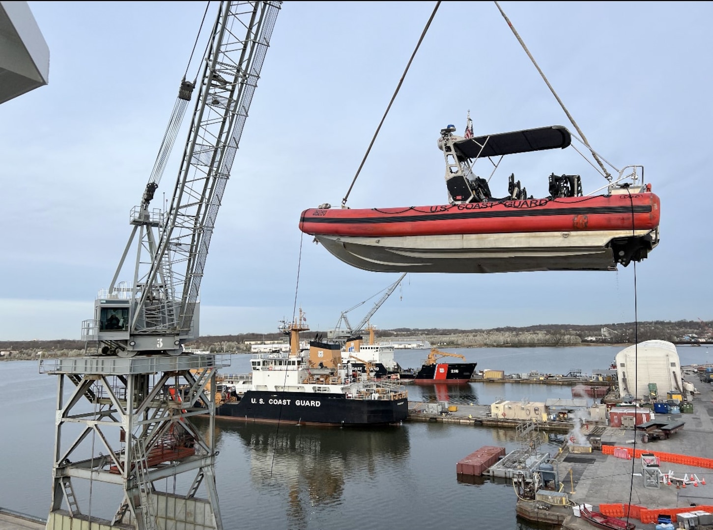 U.S. Coast Guard Cutter Diligence (WMEC 616) has one of its small boats lowered by crane into the water, March 21, 2024, while the cutter was in dry dock at the Coast Guard Yard in Baltimore, Maryland. The small boat crew later responded to the collapse of the Francis Scott Key Bridge. (U.S. Coast Guard photo by Lt. Cmdr. Brian Waller)