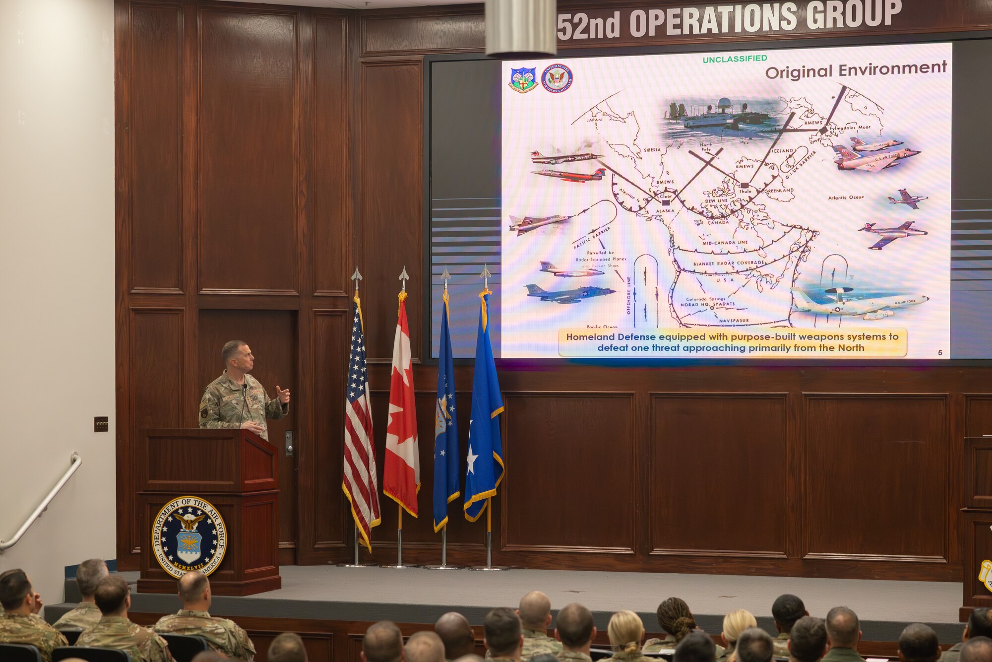 speaker looking at powerpoint screen