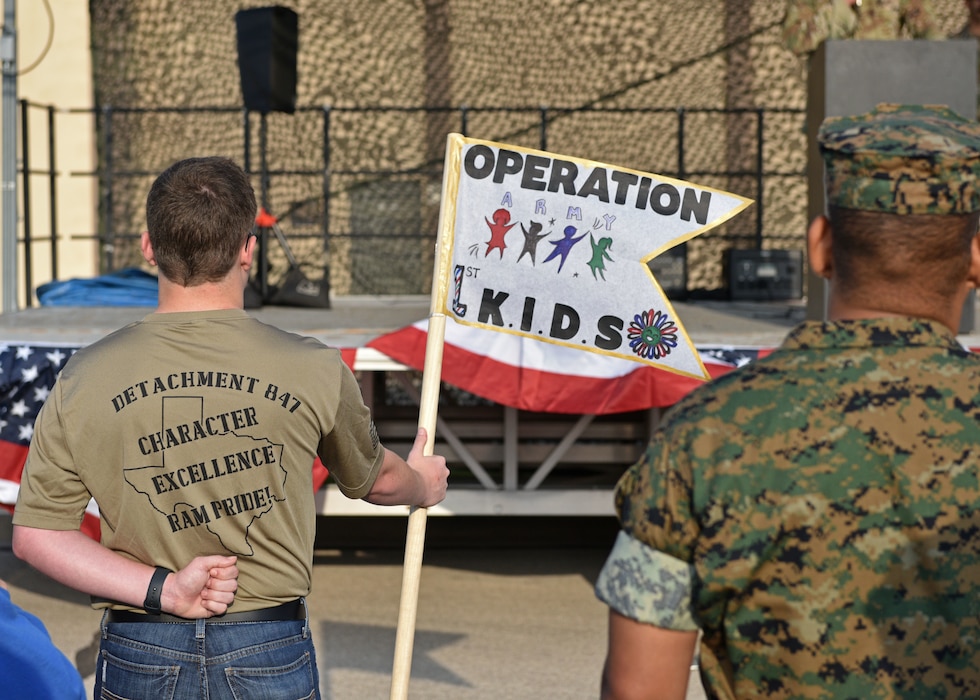 A Detachment 847 cadet holds an Operation K.I.D.S. (Kids Investigating Deployment Services) Army Guidon during morning formation at Goodfellow Air Force Base, Texas, April 27, 2024. During Operation Kids, children were separated into chalks representing the different branches on Goodfellow. (U.S. Air Force photo by 2nd Lt. Harris Hillstead)