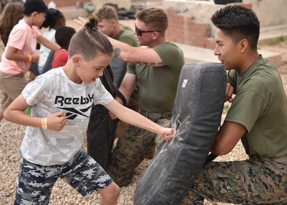 An Operation K.I.D.S. (Kids Investigating Deployment Services) participant learns Marine Corps Martial Arts at Forward Operating Base Sentinel, Goodfellow Air Force Base, Texas, April 27, 2024. Every branch stationed at Goodfellow came together to show military kids what deployed life may be like for their parents. (U.S. Air Force photo by 2nd Lt. Harris Hillstead)