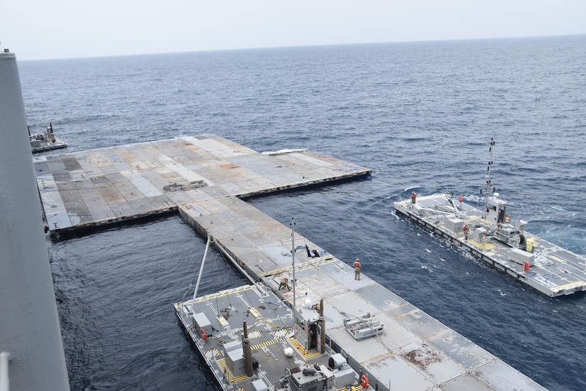 Soldiers construct a floating pier.