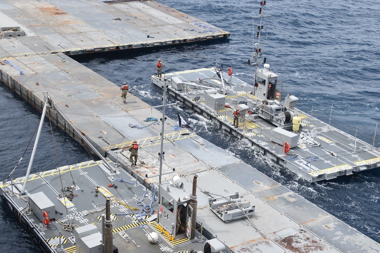 Soldiers construct a floating pier.