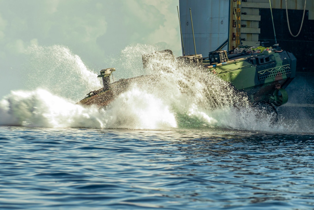 A U.S. Marine Corps amphibious combat vehicle attached to Alpha Company, Battalion Landing Team 1/5, 15th Marine Expeditionary Unit, splashes off the amphibious dock landing ship USS Harpers Ferry (LSD 49) during Exercise Balikatan 24 in Naval Detachment Oyster Bay, Palawan, Philippines, May 4, 2024. BK 24 is an annual exercise between the Armed Forces of the Philippines and the U.S. military designed to strengthen bilateral interoperability, capabilities, trust, and cooperation built over decades of shared experiences. (U.S. Marine Corps photo by Lance Cpl. Peyton Kahle)