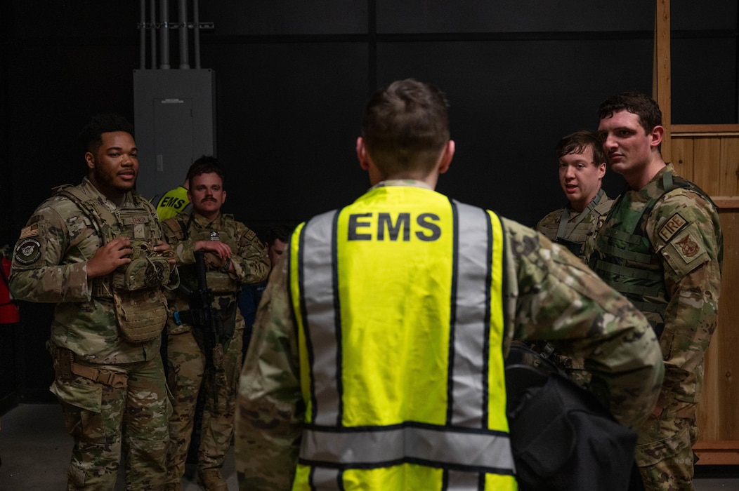 Airmen assigned to the 354th Fighter Wing debrief after a Tactical Combat Casualty Care scenario at Eielson Air Force Base, Alaska, April 25, 2024.