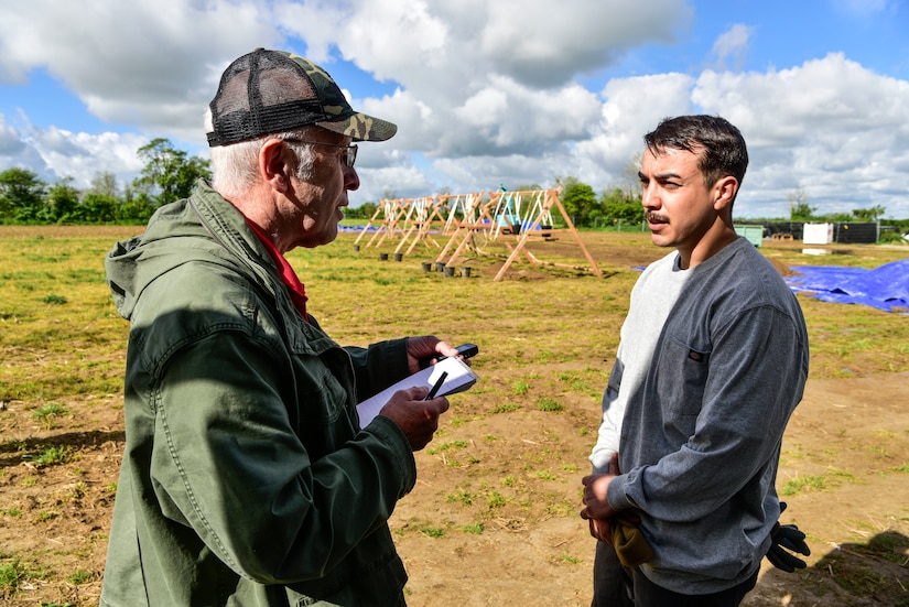 A man is interviewed by a male reporter.