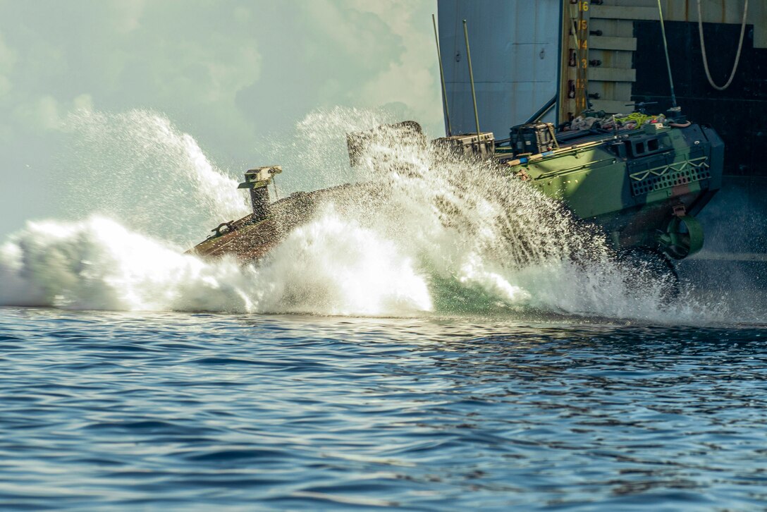 A U.S. Marine Corps amphibious combat vehicle attached to Alpha Company, Battalion Landing Team 1/5, 15th Marine Expeditionary Unit, splashes off the amphibious dock landing ship USS Harpers Ferry (LSD 49) during Exercise Balikatan 24 in Naval Detachment Oyster Bay, Palawan, Philippines, May 4, 2024. BK 24 is an annual exercise between the Armed Forces of the Philippines and the U.S. military designed to strengthen bilateral interoperability, capabilities, trust, and cooperation built over decades of shared experiences. (U.S. Marine Corps photo by Lance Cpl. Peyton Kahle)