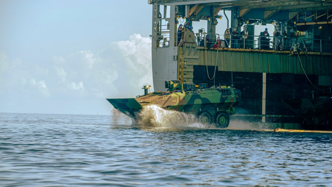 A U.S. Marine Corps amphibious combat vehicle attached to Alpha Company, Battalion Landing Team 1/5, 15th Marine Expeditionary Unit, splashes off the amphibious dock landing ship USS Harpers Ferry (LSD 49) during Exercise Balikatan 24 in Naval Detachment Oyster Bay, Palawan, Philippines, May 4, 2024. BK 24 is an annual exercise between the Armed Forces of the Philippines and the U.S. military designed to strengthen bilateral interoperability, capabilities, trust, and cooperation built over decades of shared experiences. (U.S. Marine Corps photo by Lance Cpl. Peyton Kahle)