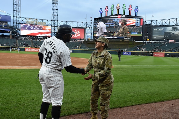 U.S. Army Reserve Staff Sgt. Christina House meets Chicago White Sox Third Base Coach, Eddie Bourgeois, left, April 26, 2024, at Guaranteed Rate Field in Chicago, Illinois.