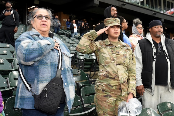 U.S. Army Reserve Staff Sgt. Christina House salutes during the Star-Spangled Banner, April 26, 2024, Guaranteed Rate Field in Chicago, Illinois.