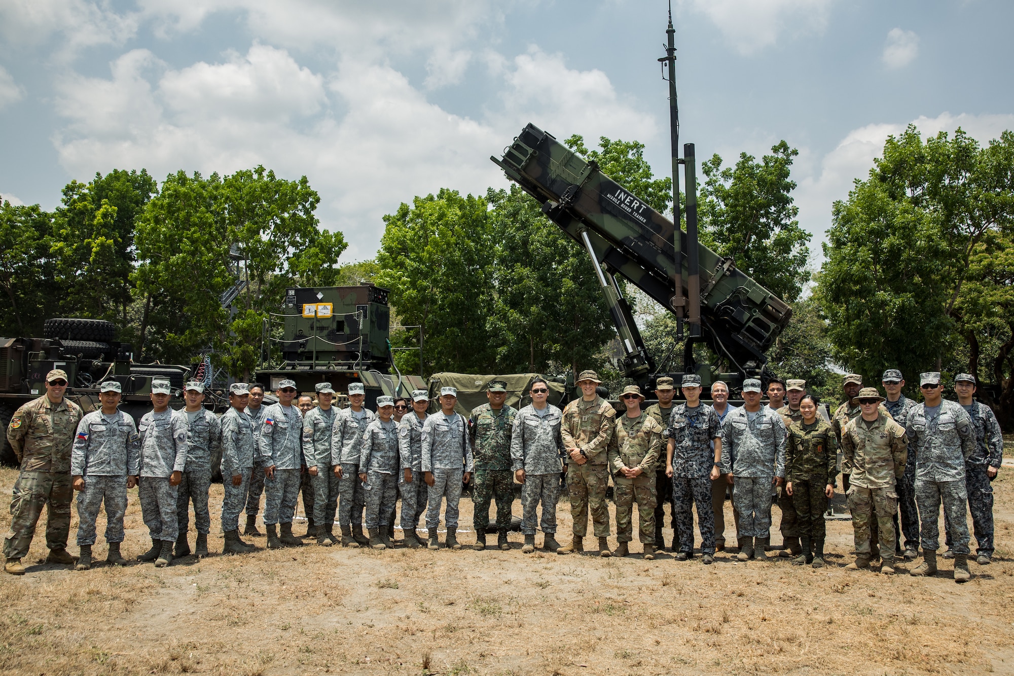 Service members from the Armed Forces of the Philippines, U.S. Military, and Japan Air Self-Defense Force stand in front of the Patriot M903 Launching Station belonging to Bravo Battery, 1-1 Air Defense Artillery, as part of the week-long Joint Integrated Air And Missile Defense exchange during Exercise Balikatan 24 at Clark Air Base, Philippines, April 25, 2024. BK 24 is an annual exercise between the Armed Forces of the Philippines and the U.S. military designed to strengthen bilateral interoperability, capabilities, trust, and cooperation built over decades of shared experiences. (U.S. Army photo by Maj. Trevor Wild)