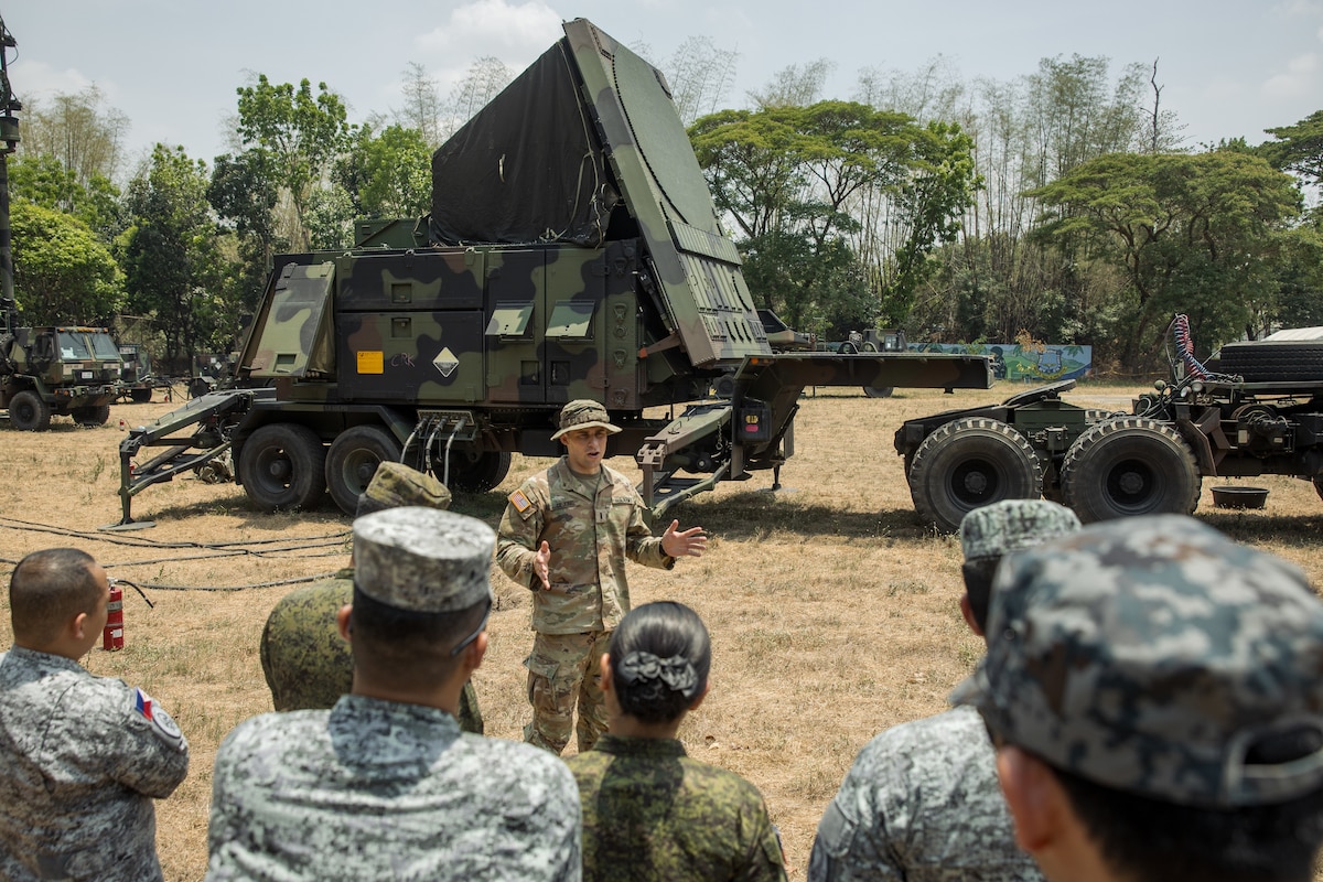 U.S. Army 1st Lt. Christian de Jong, Bravo Battery, 1-1 Air Defense Artillery, 38th Air Defense Brigade, explains the capabilities of the AN/MPQ-65 Radar to the multilateral attendees of the Joint Integrated Air And Missile Defense exchange during Exercise Balikatan 24 at Clark Air Base, Philippines, April 25, 2024. BK 24 is an annual exercise between the Armed Forces of the Philippines and the U.S. military designed to strengthen bilateral interoperability, capabilities, trust, and cooperation built over decades of shared experiences. (U.S. Army photo by Maj. Trevor Wild)