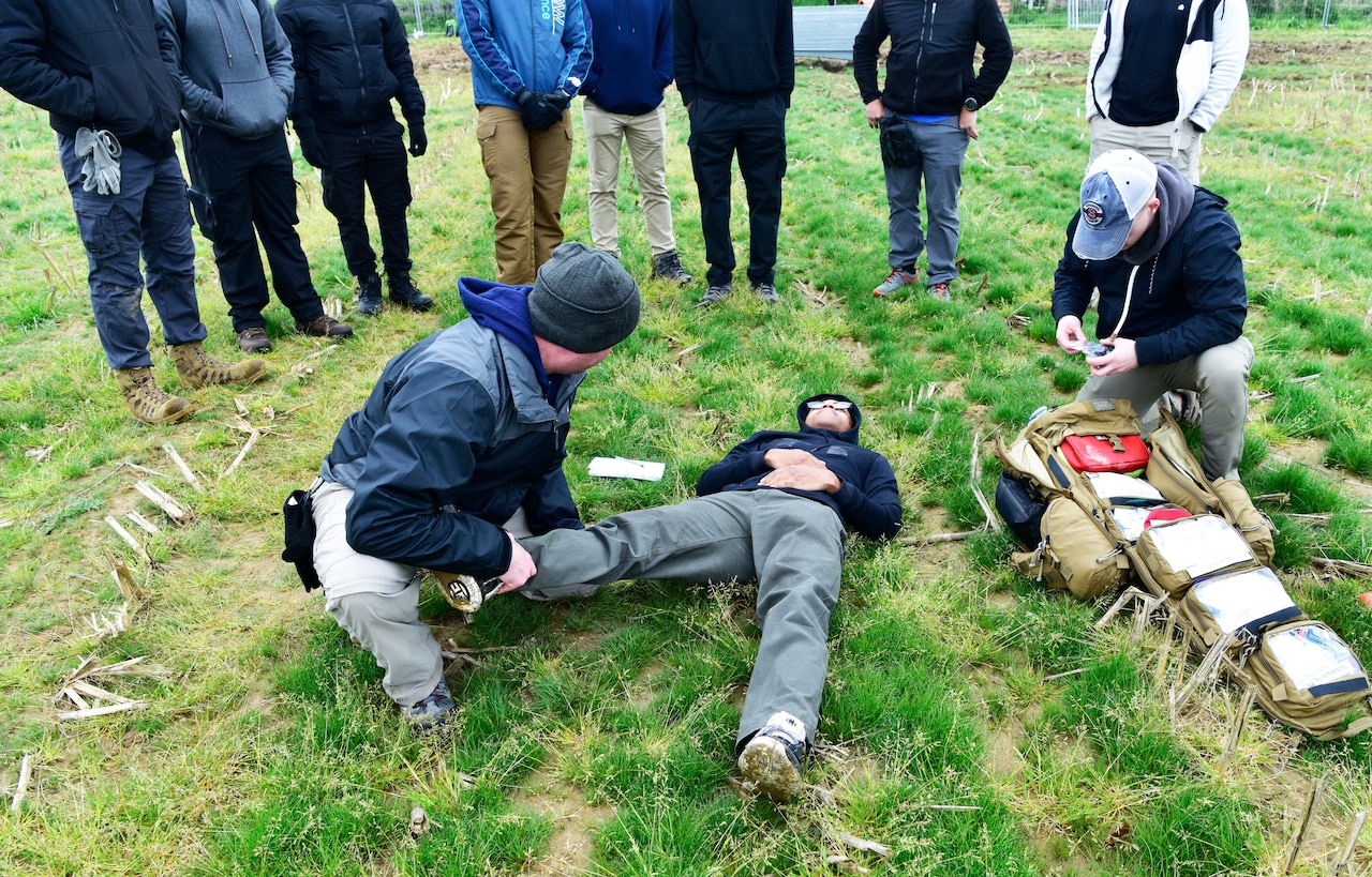 Medical personnel treat a simulated patient.