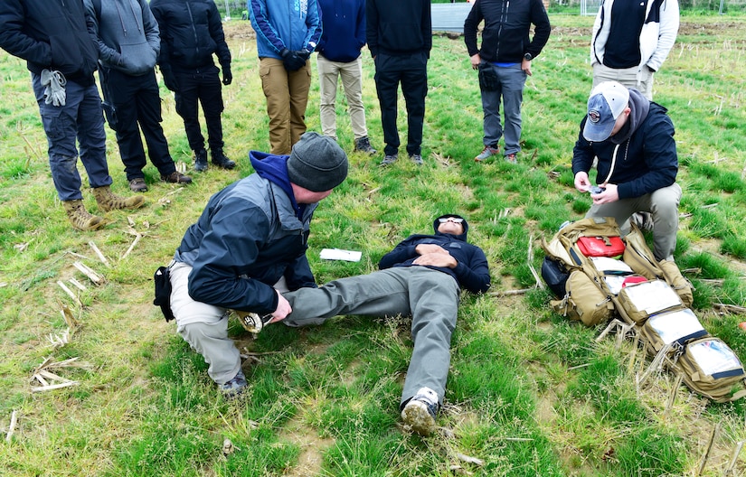 Medical personnel treat a simulated patient.