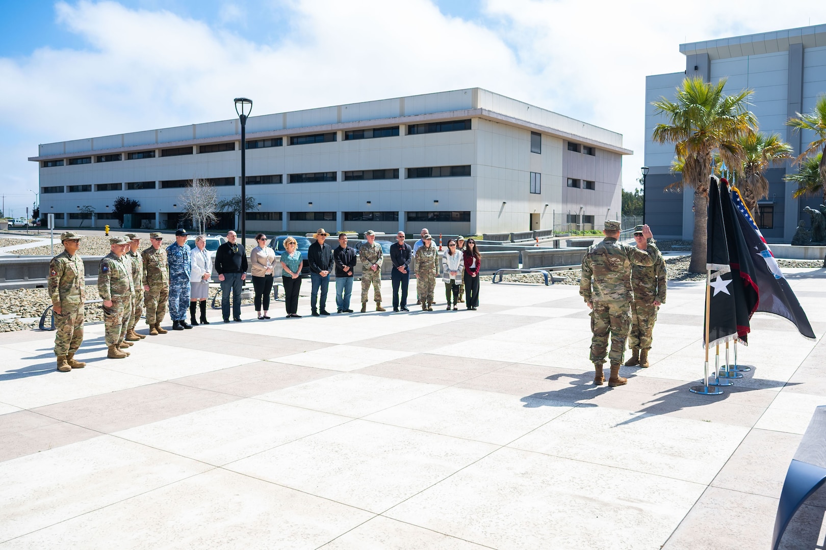 A general stands in front of a group during a promotion ceremony.