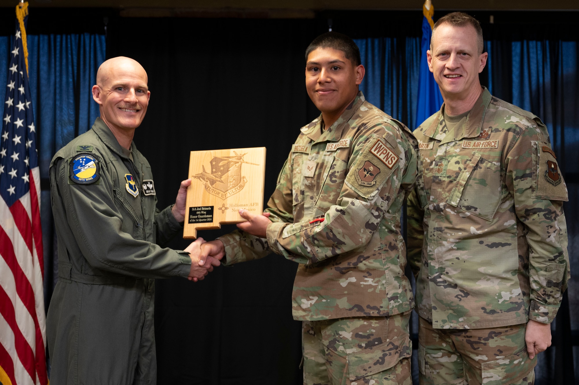 U.S. Air Force Senior Airman Joel Brizuela, 8th Aircraft Maintenance Unit weapons load crew member, accepts the 49th Wing’s Honor Guardsman of the Quarter Award, during the 49th Wing’s 1st Quarter Award ceremony at Holloman Air Force Base, New Mexico, May 3, 2024. Quarterly award winners were selected based on their technical expertise, demonstration of leadership and job performance. (U.S. Air Force photo by Airman 1st Class Michelle Ferrari)