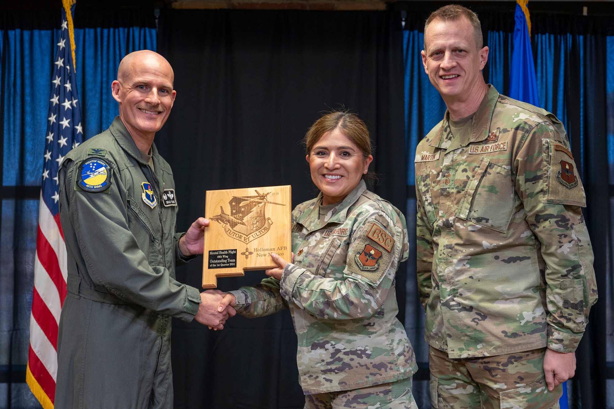 U.S. Air Force Maj. Regina Ortega, from the 49th Mental Health Flight, accepts the 49th Wing’s Outstanding Team of the Quarter Award, during the 49th Wing’s 1st Quarter Award ceremony at Holloman Air Force Base, New Mexico, May 3, 2024. Quarterly award winners were selected based on their technical expertise, demonstration of leadership and job performance. (U.S. Air Force photo by Airman 1st Class Michelle Ferrari)