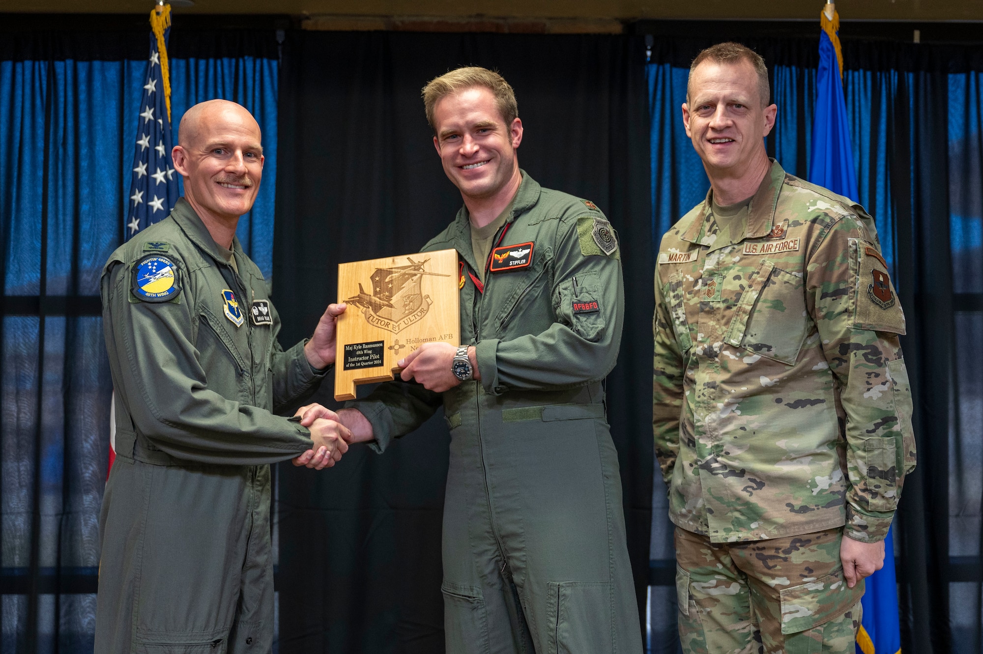 U.S. Air Force Maj. Kyle Rasmussen, 54th Training Squadron instructor pilot, accepts the 49th Wing Instructor Pilot of the Quarter Award, during the 49th Wing’s 1st Quarter Award ceremony at Holloman Air Force Base, New Mexico, May 3, 2024. Quarterly award winners were selected based on their technical expertise, demonstration of leadership and job performance. (U.S. Air Force photo by Airman 1st Class Michelle Ferrari)
