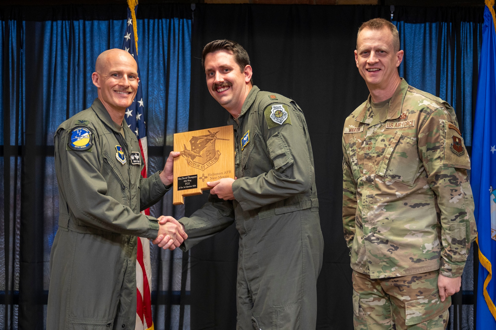 U.S. Air Force Maj. David Thompson, 16th Training squadron director of operations, accepts the 49th Wing Field Grade Officer of the Quarter Award, during the 49th Wing’s 1st Quarter Award ceremony of Holloman Air Force Base, New Mexico, May 3, 2024. Quarterly award winners were selected based on their technical expertise, demonstration of leadership and job performance. (U.S. Air Force photo by Airman 1st Class Michelle Ferrari)