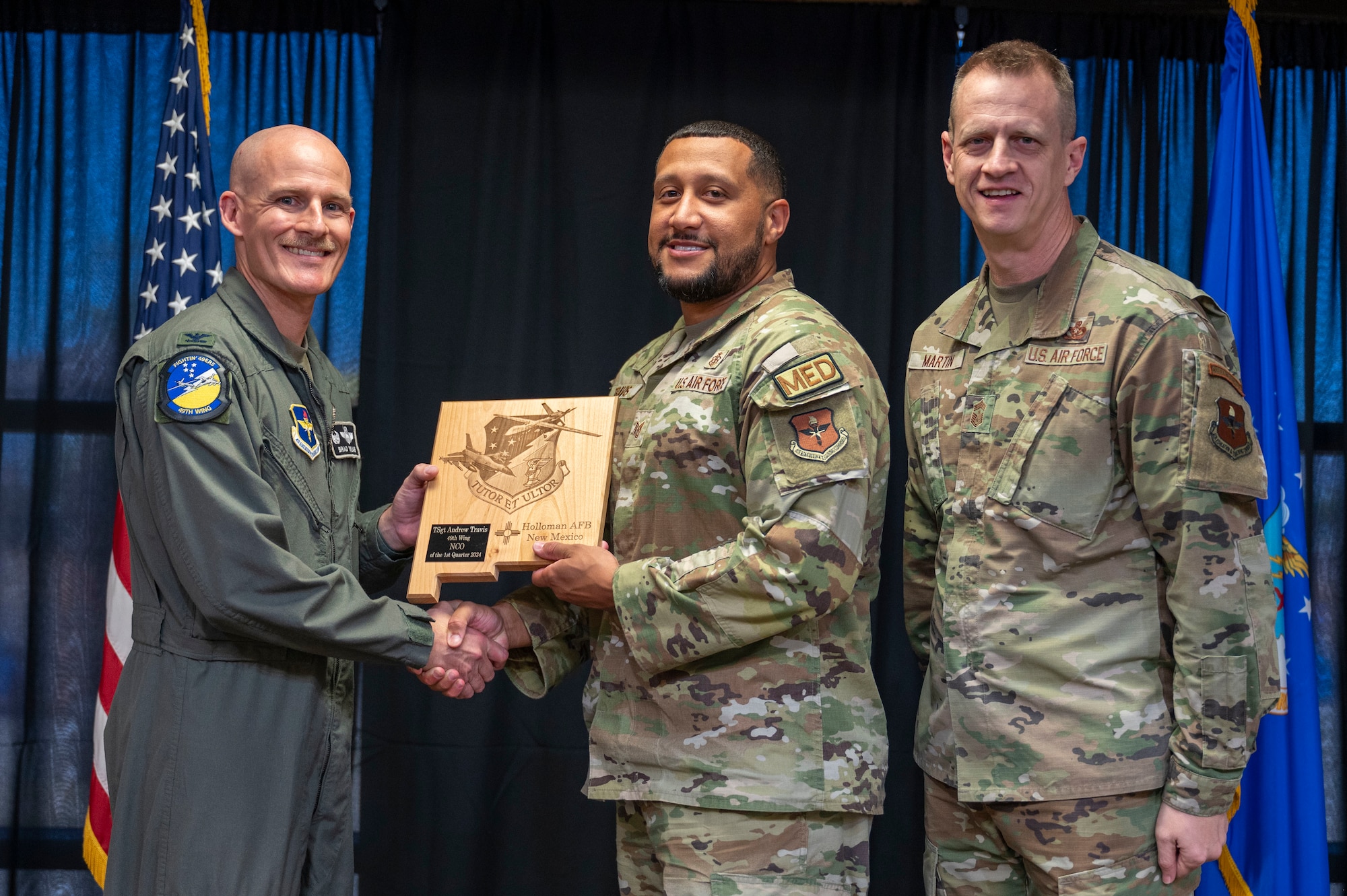 U.S. Air Force TSgt. Andrew Travis, from the 49th Operational Medical Readiness Squadron, accepts the 49th wing Noncomissioned Officer of the Quarter Award, during the 49th Wing’s 1st Quarter Award ceremony at Holloman Air Force Base, New Mexico, May 3, 2024. Quarterly award winners were selected based on their technical expertise, demonstration of leadership and job performance. (U.S. Air Force photo by Airman 1st Class Michelle Ferrari)