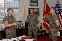 U.S. Marine Corps Brigadier General Adam Chalkley, left, the commanding general of 3rd Marine Logistics Group (MLG), speaks with Lance Cpl. Cruz Mendez, center, a financial technician with Combat Logistics Regiment 37, 3rd MLG, and Cpl. Hunter Bush, a bulk fuel specialist with 9th Engineer Support Battalion, Combat Logistics Regiment 3, 3rd MLG, on Camp Kinser, Okinawa, Japan, May 2, 2024. Mendez is a native of New York. Bush is a native of Illinois. Mendez and Bush were recognized as Marine of the Quarter and Non-Commissioned Officer of the Quarter for performing above and beyond expectations set by their units. (U.S. photo by Sgt. Christian M. Garcia)