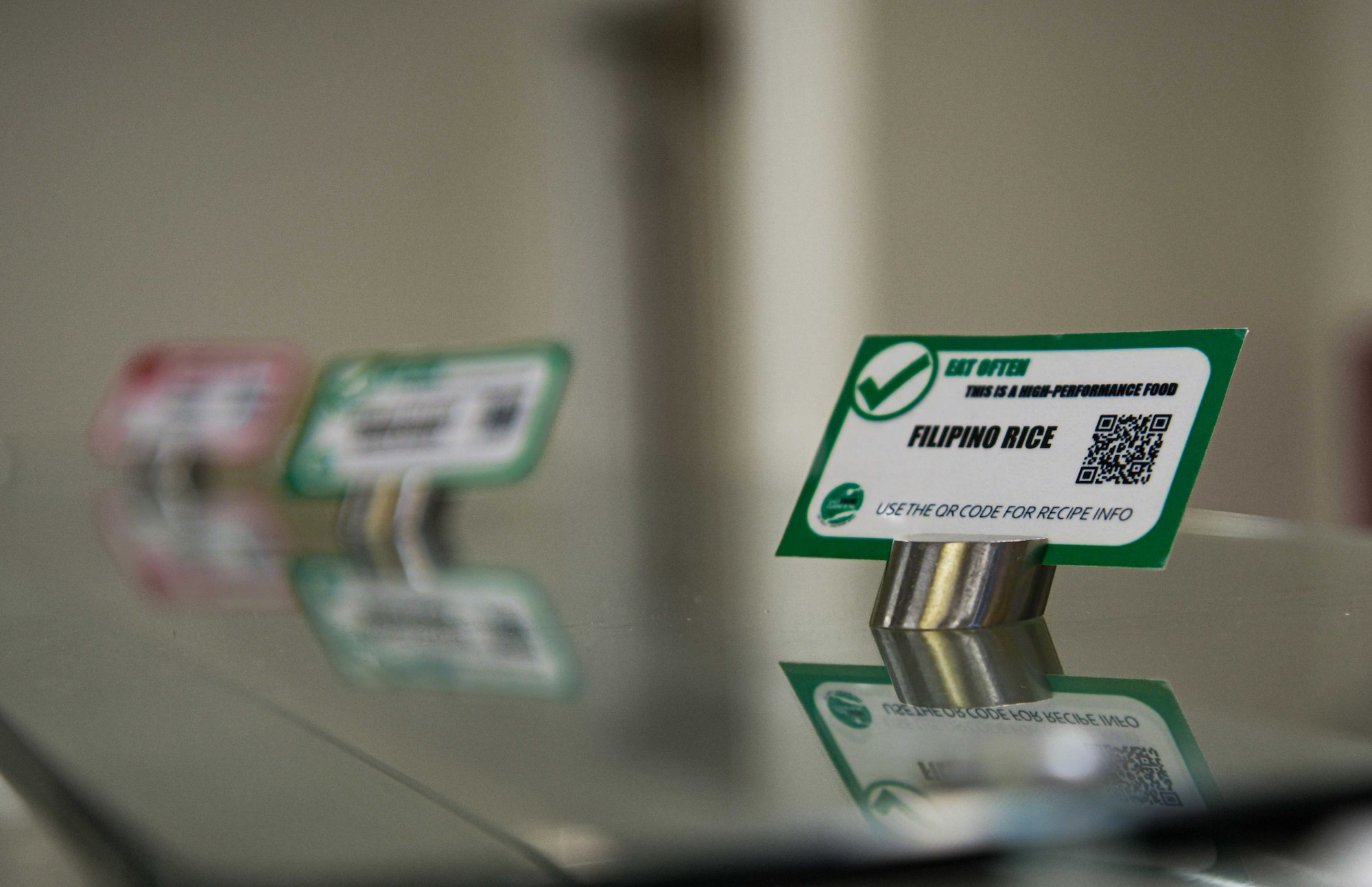 Green and red nutritional labels are displayed on a glass counter in the Marshall DFAC.