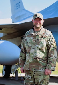 Capt. Bryon Adams, Jr. in front of an F-16 at CONR-1AF (AFNORTH and AFSPACE) headquarters.