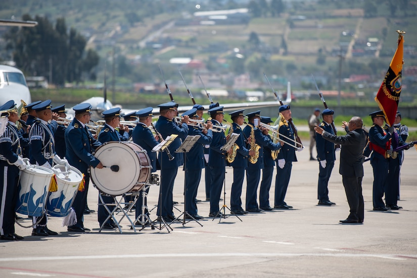 An Ecuadorian Air Force band plays during a ceremony welcoming the arrival of a C-130H Hercules to the Ecuadorian Air Force in Latacunga, Ecuador, March 25, 2024. The ceremony, which included top Ecuadorian military and civilian leaders, marked a new milestone in Ecuador’s participation in the National Guard Bureau State Partnership Program, which has paired Ecuador and the Kentucky National Guard for mutual military cooperation. (U.S. Air National Guard photo by Phil Speck)