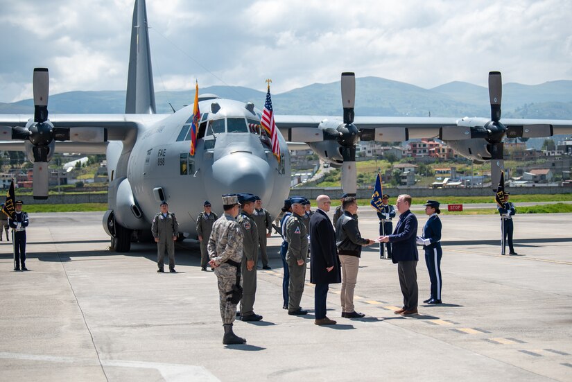 Ecuador President Daniel Noboa, center left, and U.S. Ambassador to Ecuador Michael Fitzpatrick shake hands representing the joint partnership between the United States and Ecuador during a ceremony welcoming the arrival of a C-130H Hercules to the Ecuadorian Air Force in Latacunga, Ecuador, March 25, 2024. The ceremony marked a new milestone in Ecuador’s participation in the National Guard Bureau State Partnership Program, which has paired Ecuador and the Kentucky National Guard for mutual military cooperation. (U.S. Air National Guard photo by Phil Speck)