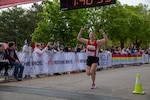 Nebraska National Guard runner Maj. Amanda Schmid crosses the finish line of the 47th annual Lincoln Marathon and Half Marathon May 5, 2024, in Lincoln, Nebraska.